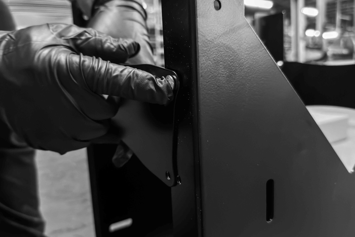 Dog-bone cross brace being bolted to the chassis